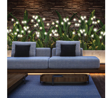 Nexxt Solar Tuinlampen Firefly zorgen voor warme sfeerverlichting langs een tuinbank en plantenborder.