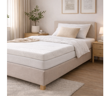 Vitality Pur Luxe eenpersoons topdekmatras op een boxspring in een lichte slaapkamer voor extra comfort en ondersteuning.