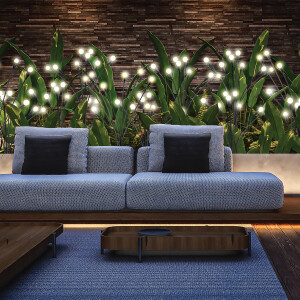 Nexxt Solar Tuinlampen Firefly zorgen voor warme sfeerverlichting langs een tuinbank en plantenborder.